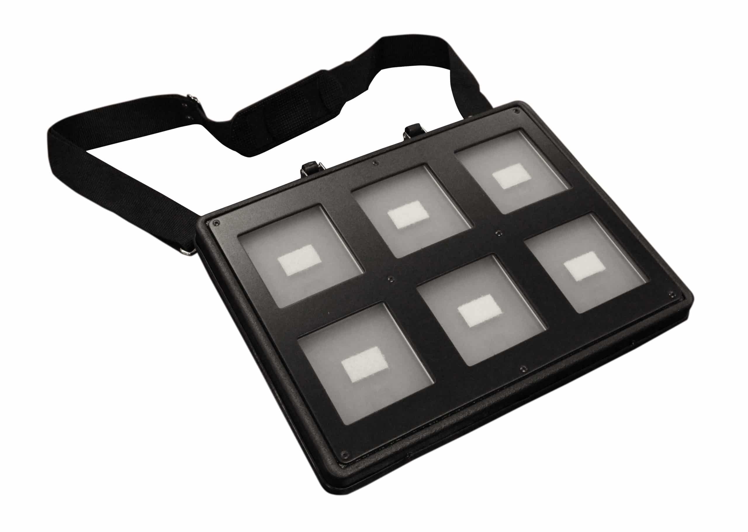 A flat rectangular device with rows of square cells fitted with raised tactile icons attached by Velcro.