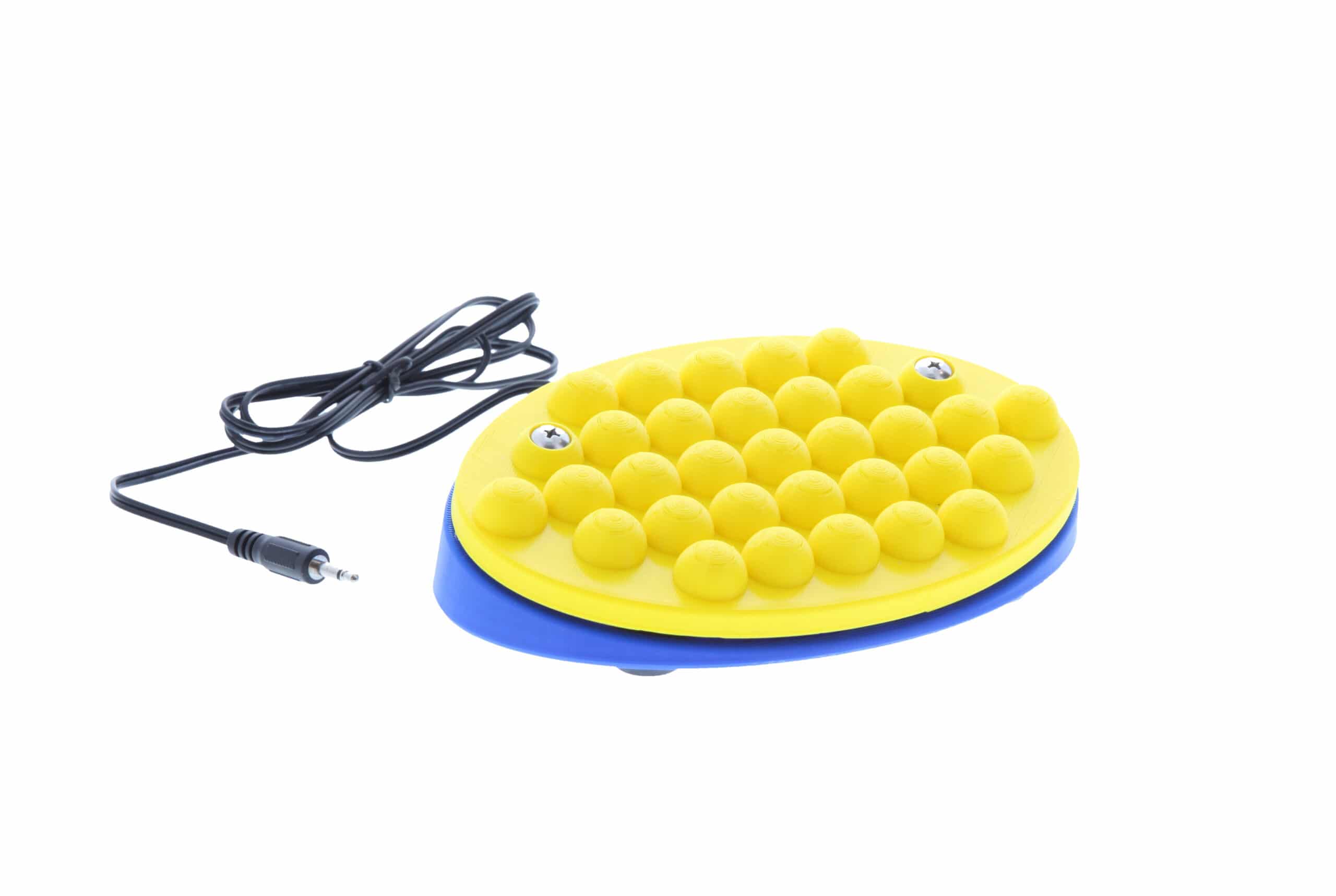 A large rectangular bright yellow switch with a raised bumpy textured surface and a cable.