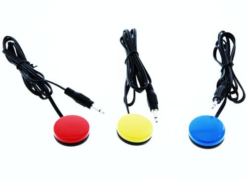 A set of three small round capability switches, each with an attached cable ending in a plug.
