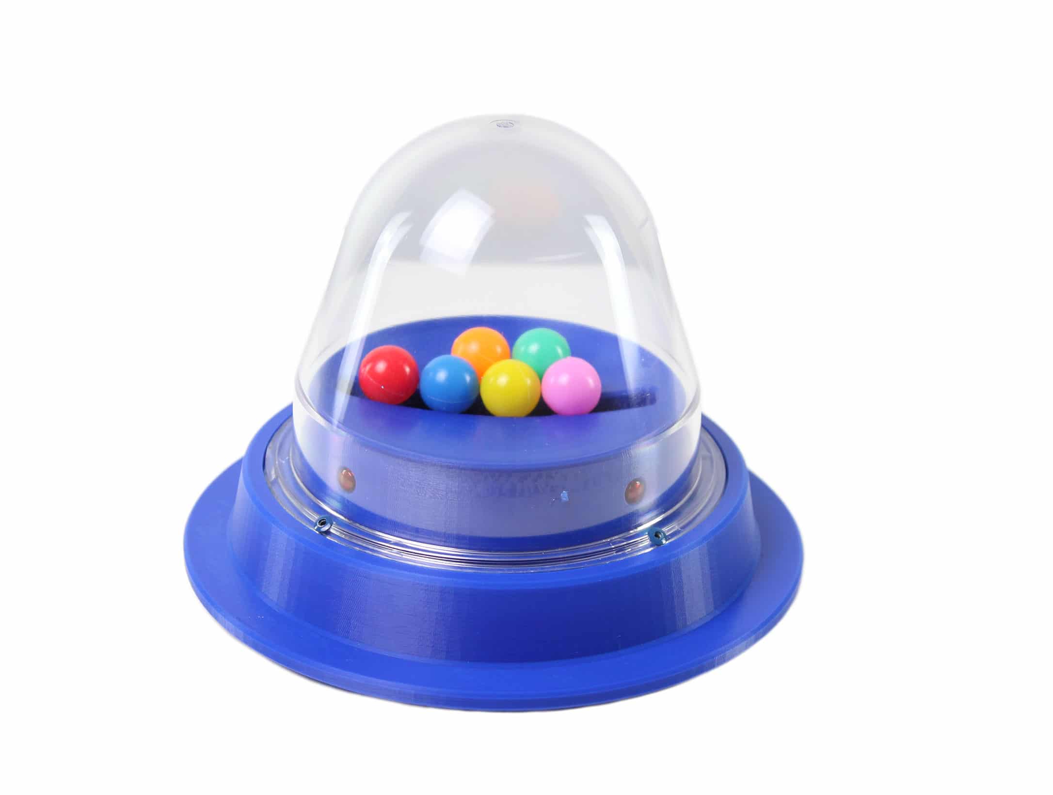 A round clear-domed popper toy on a colored base, containing small balls that bounce inside the dome when activated.