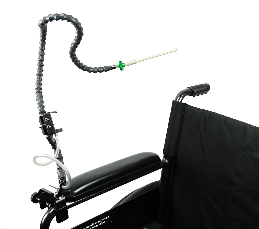 A sip-and-puff switch with a straw mouthpiece on long flexible black tubing attached to a three-way mounting clip.