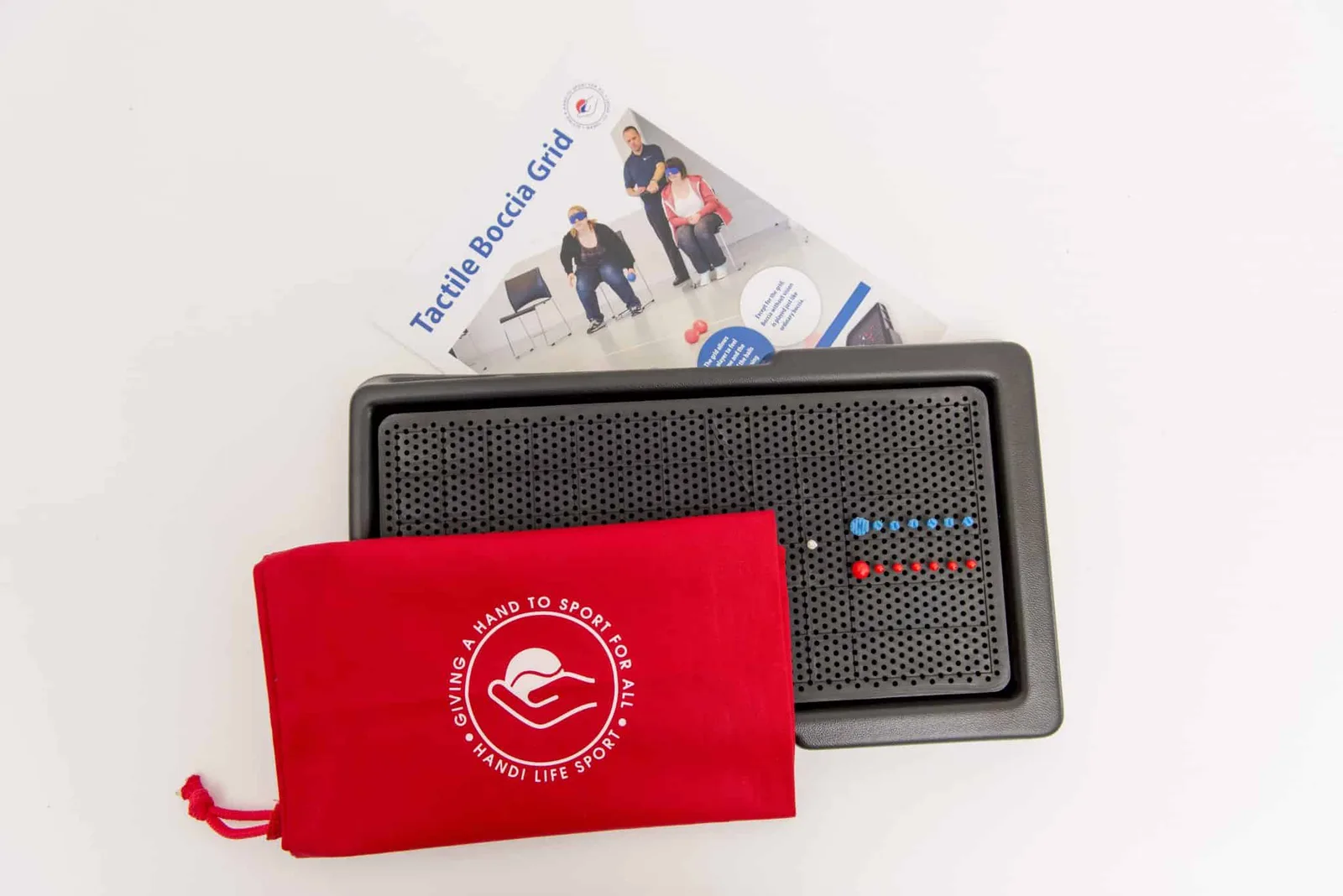 Black tactile boccia grid board with rows of red and blue pegs and one white peg, a red storage pouch and an instruction sheet.