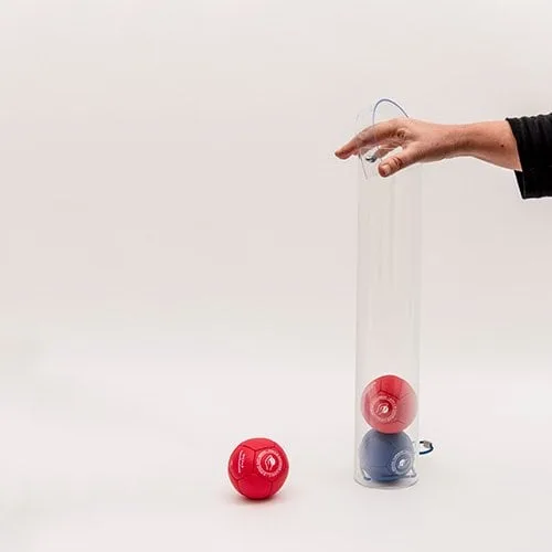 A clear acrylic tube collecting red and blue boccia balls, held by a hand by its loop handle.