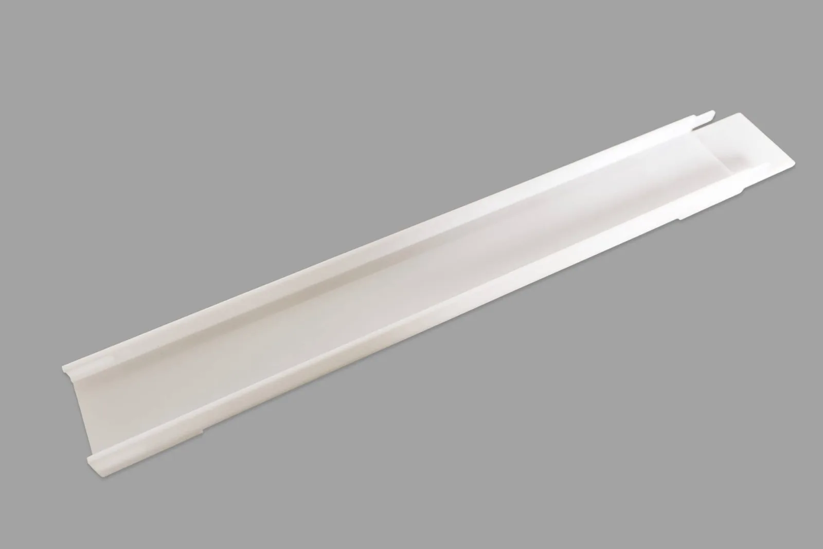 A long, clear polycarbonate ramp section with a channel and connector tabs.