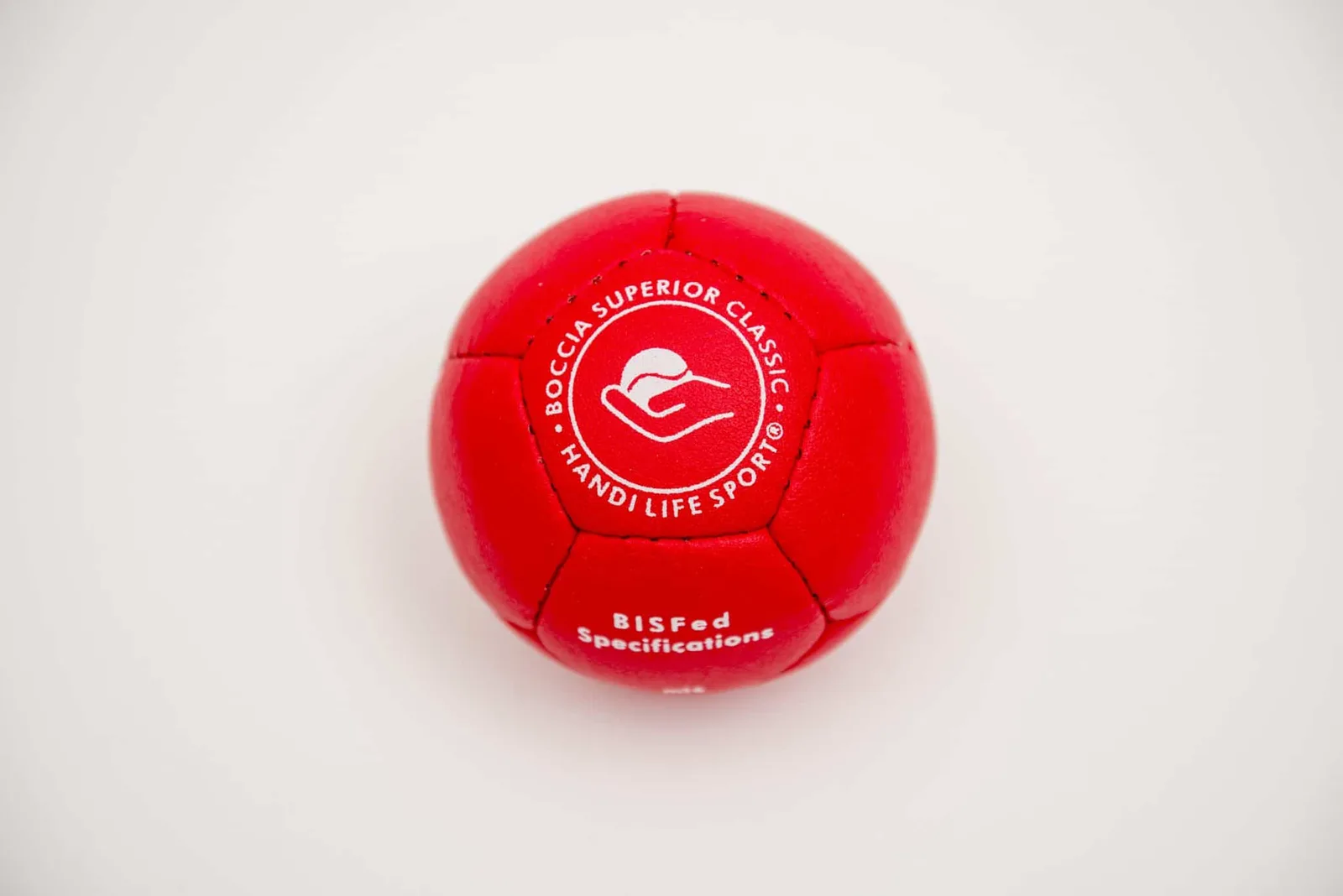 A single red leather boccia ball stamped with the Handi Life Sport logo and “Boccia Superior Classic”.