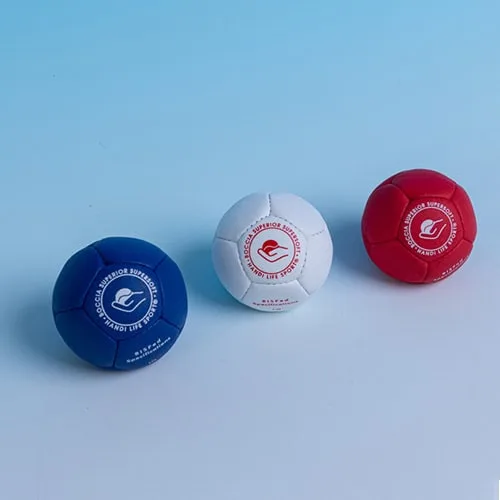 Three Superior Supersoft boccia balls in navy, white and red.