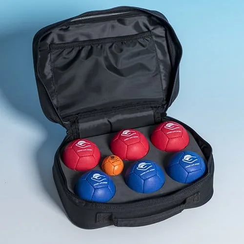 An open black case holding six soft red and blue petanque balls and one orange target ball.