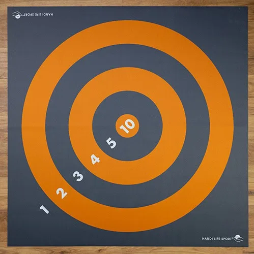 A square target mat with orange scoring rings numbered 1 to 10 on a dark grey background.