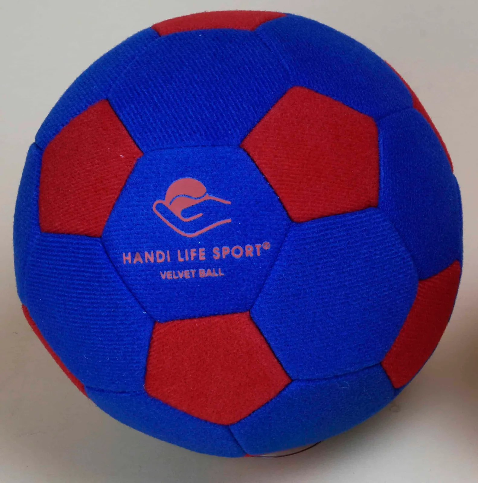 A soft blue and red velvet-covered ball marked “Velvet Ball”.