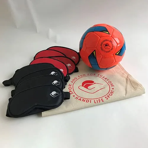 An orange blind football, a stack of red and black blindfold masks, and a cotton bag.