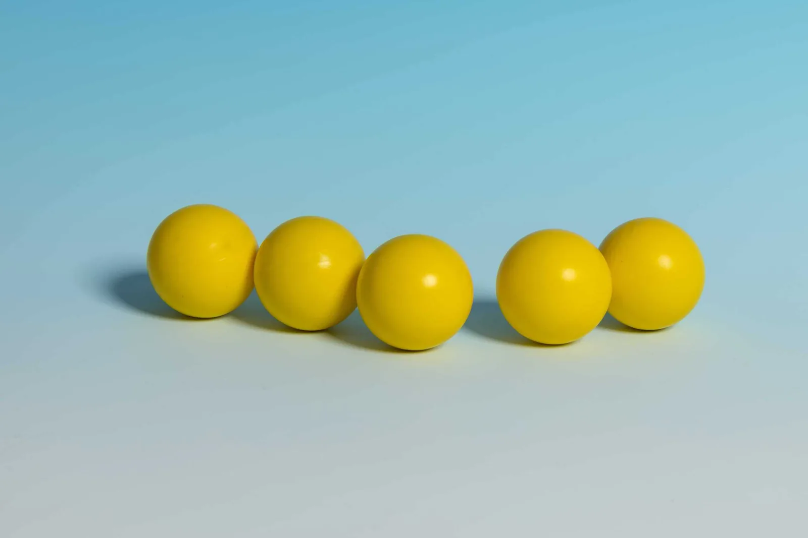 Five yellow showdown balls in a row.