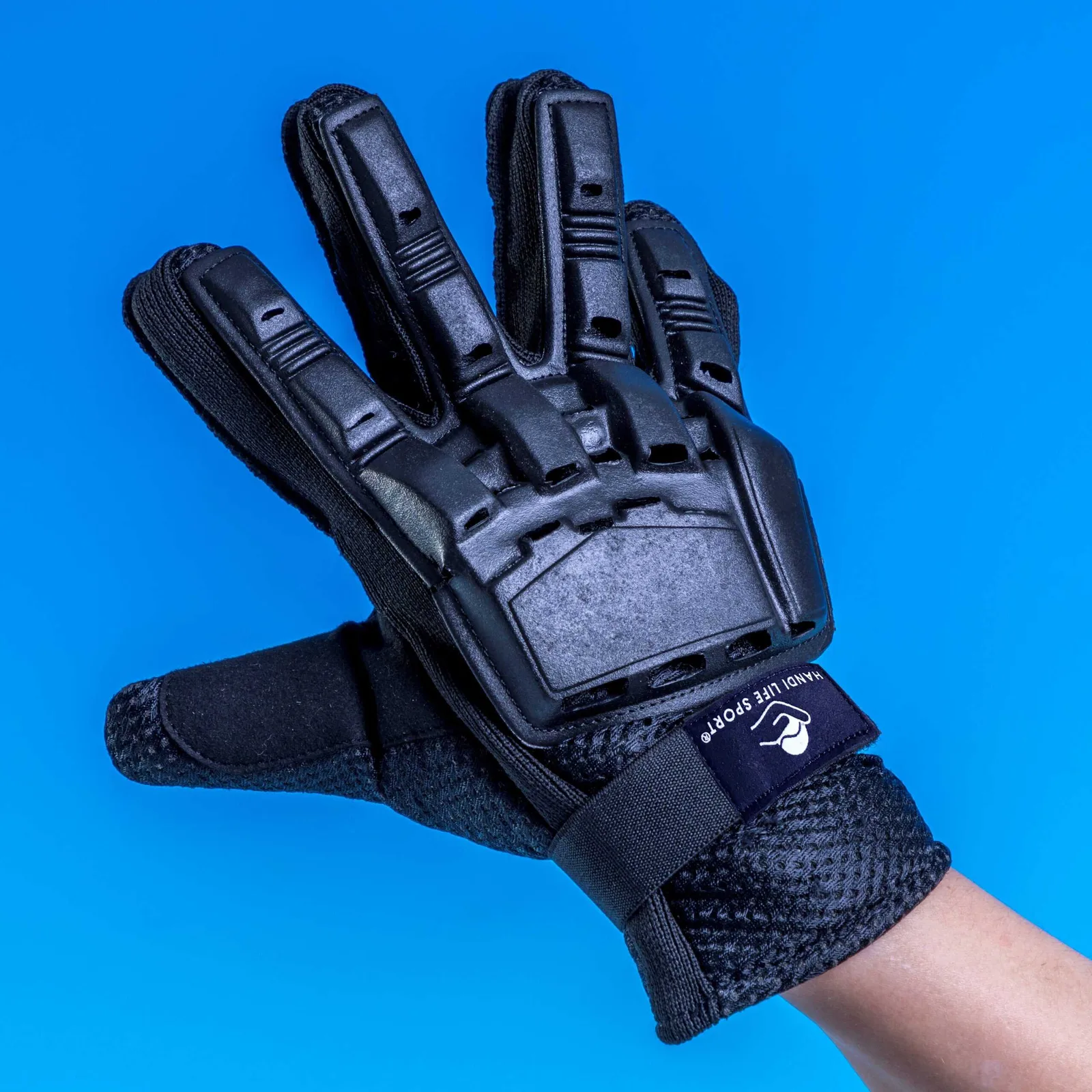 A black padded showdown glove with hard moulded knuckle guards, worn on a hand.