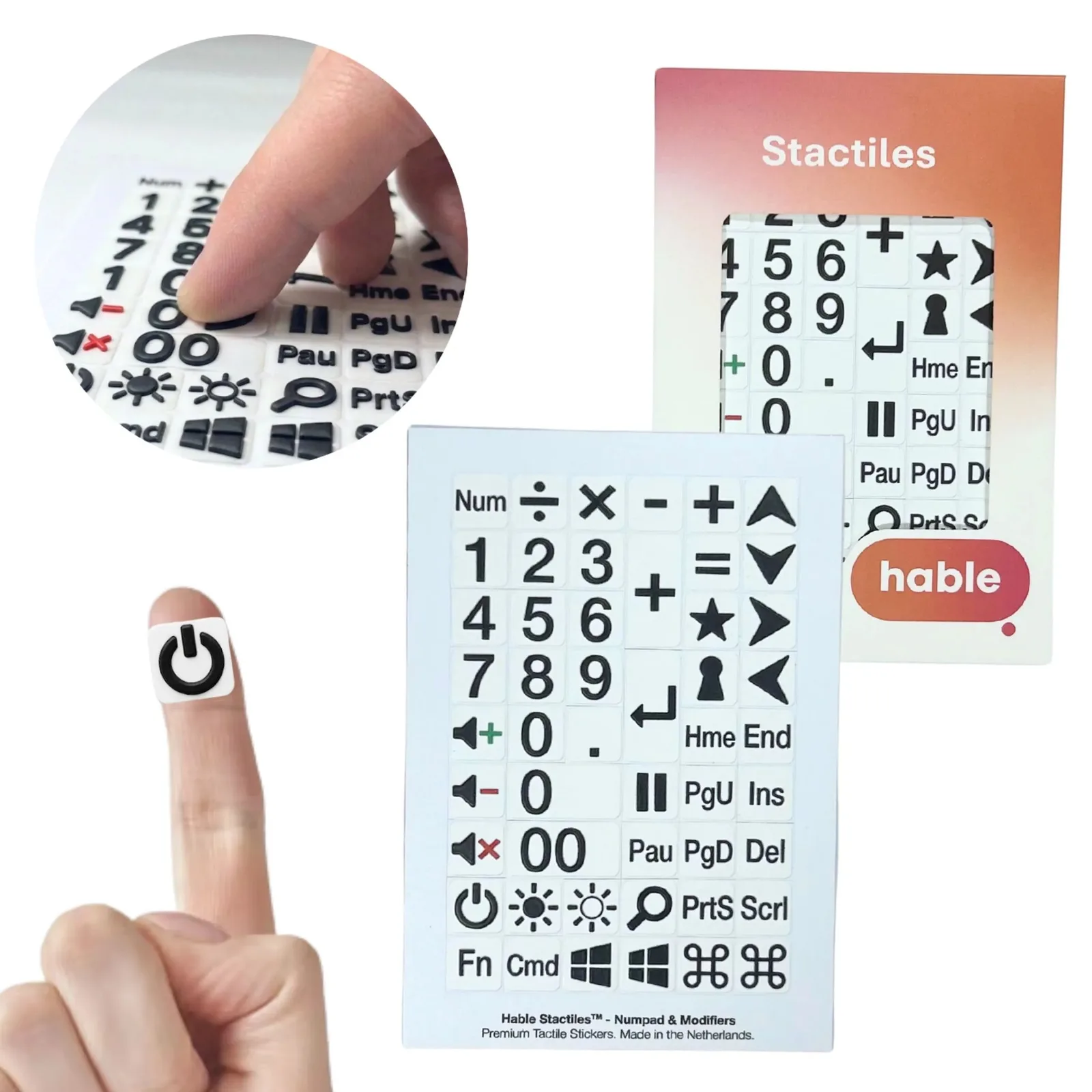 The Hable Stactiles Numpad and Modifiers set: a white sheet of black-on-white stickers including the numeric keypad, maths symbols, volume, brightness, power and navigation keys such as Home, End, Page Up and Page Down, shown with its orange box. A fingertip holds a single power-button sticker and an inset shows fingers feeling the keys.