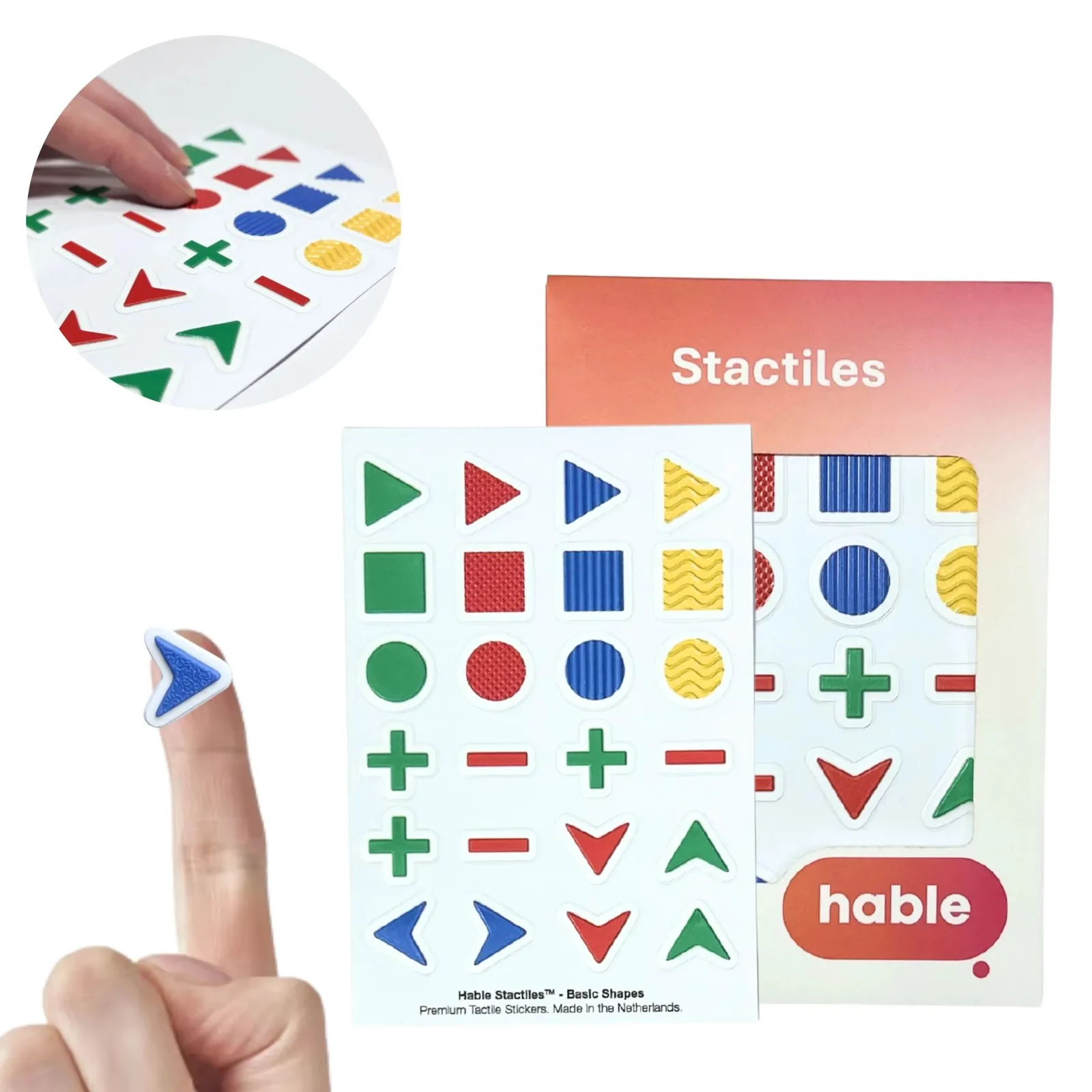 The Hable Stactiles Basic Shapes set: a white sheet of raised shapes in green, red, blue and yellow, each with a different surface texture, including triangles, squares, circles, plus and minus signs and directional arrows, shown with its orange box. A fingertip holds a single blue arrow sticker and an inset shows fingers feeling the shapes.