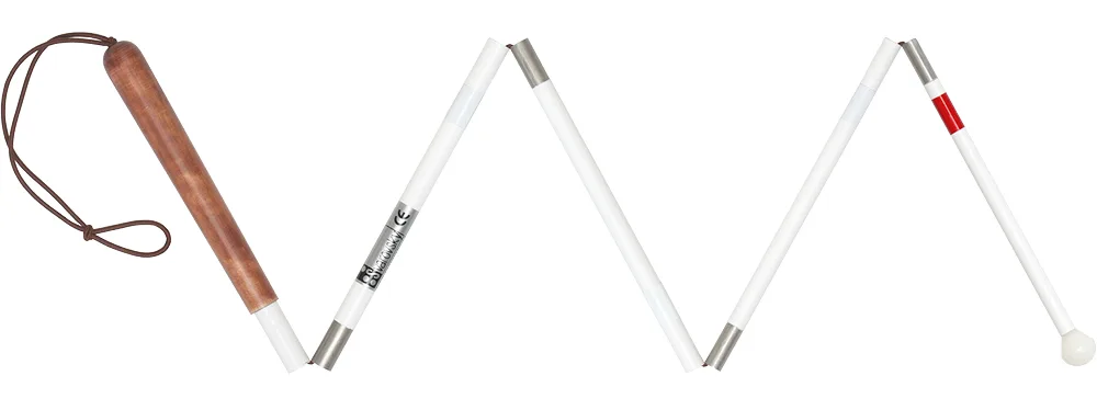 Folded five-section white cane: brown birch-wood handle with leather loop, white reflective shaft, red band and white rounded tip.