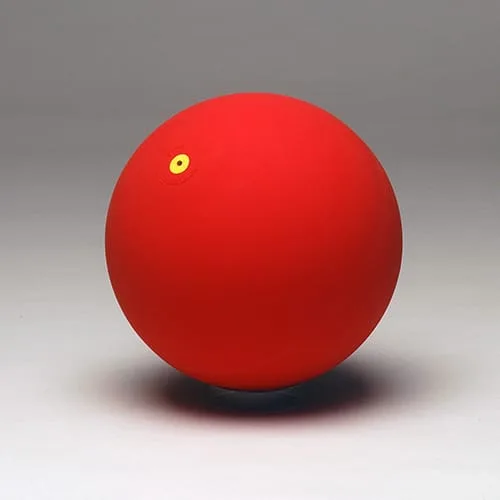 A plain matt red rubber ball with a small yellow valve disc near the top.